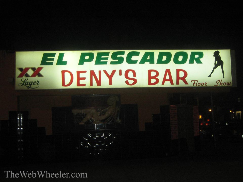 Illuminated nighttime sign reading El Pescador Deny's Bar Floor Show with XX Lager logo