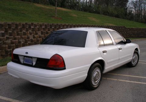 2001 Ford Crown Victoria - Rear 3/4 view of a white 2001 Ford Crown Victoria with tinted windows.