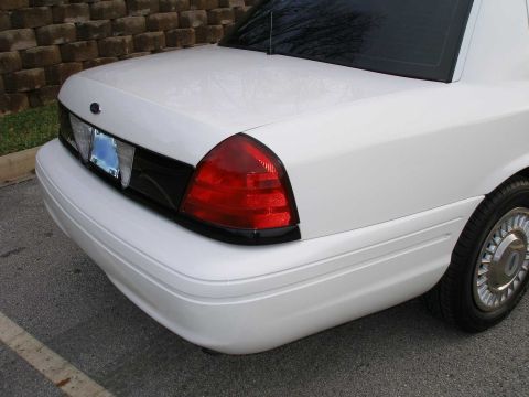 2001 Ford Crown Victoria - Rear view of a white 2001 Ford Crown Victoria showing its distinctive taillight and body lines.