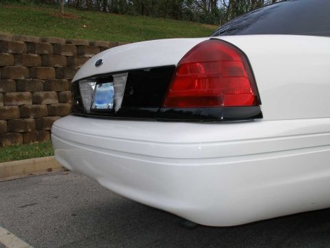 2001 Ford Crown Victoria - Rear view of a white 2001 Ford Crown Victoria, highlighting the taillight and bumper.