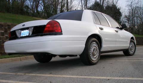2001 Ford Crown Victoria - Rear view of a white 2001 Ford Crown Victoria sedan parked outdoors.