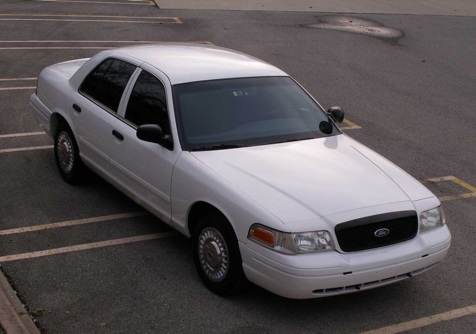 White 2001 Ford Crown Victoria sedan parked in a lot