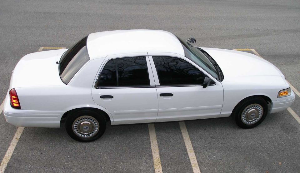 White 2001 Ford Crown Victoria parked in a lot. Side view