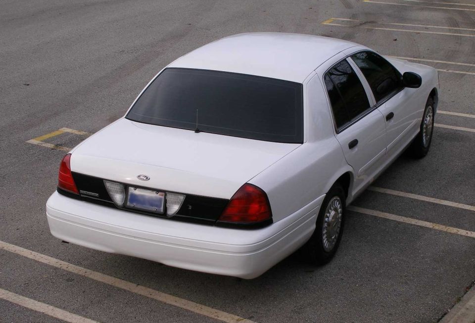 White 2001 Ford Crown Victoria parked in a lot, rear view