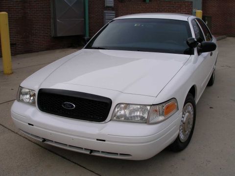 2001 Ford Crown Victoria - Front quarter view of a white 2001 Ford Crown Victoria parked outdoors.