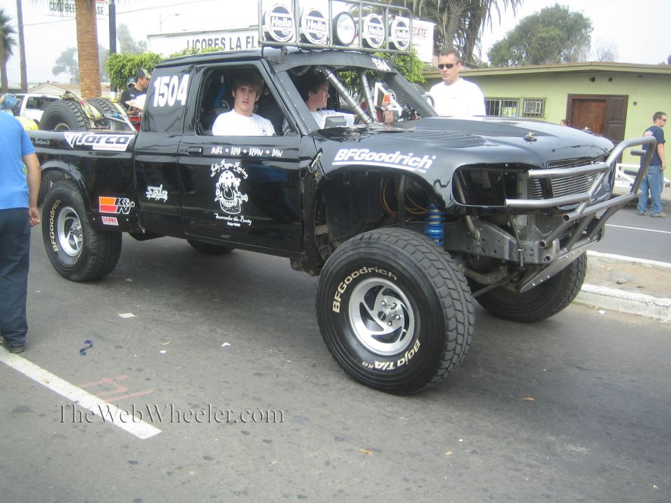 Black single-cab prerunner race truck number 1504 with exposed front suspension