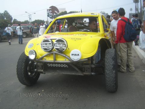1990 Ford Bronco - Front view of a yellow Baja Bug race car fitted with Hella and PIAA driving lights and a tube bumper.