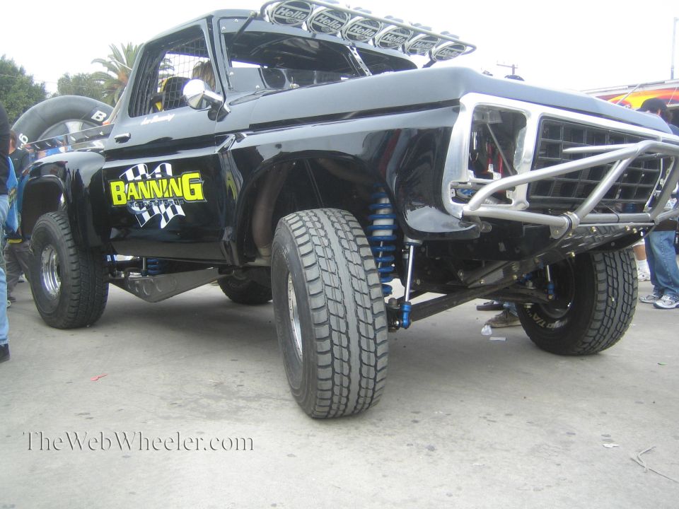 Black classic Ford prerunner truck side view with exposed suspension