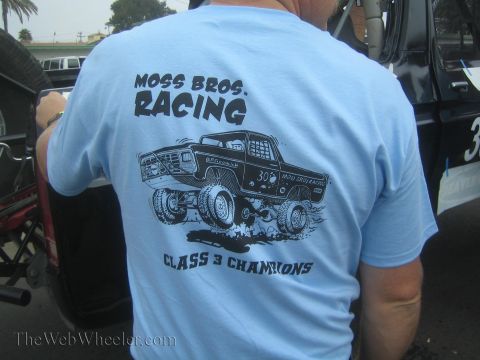 1990 Ford Bronco - back of a man's light blue T-shirt shows a Moss Bros Racing graphic with a truck illustration and Class 3 Champions text.