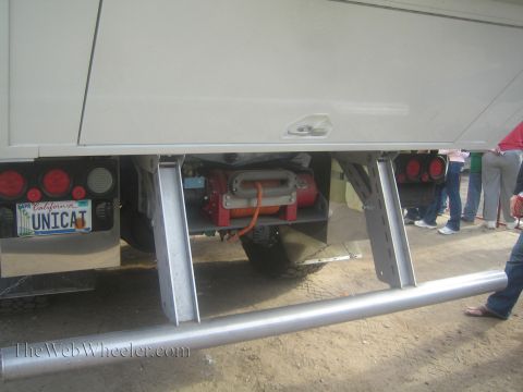 1990 Ford Bronco - Underbody view of a large vehicle showing aluminum frame steps, a red winch and a California license plate reading UNICAT.