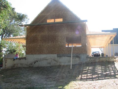 1992 Ford Bronco - A car is visible under a carport at a construction site where a house is being built.