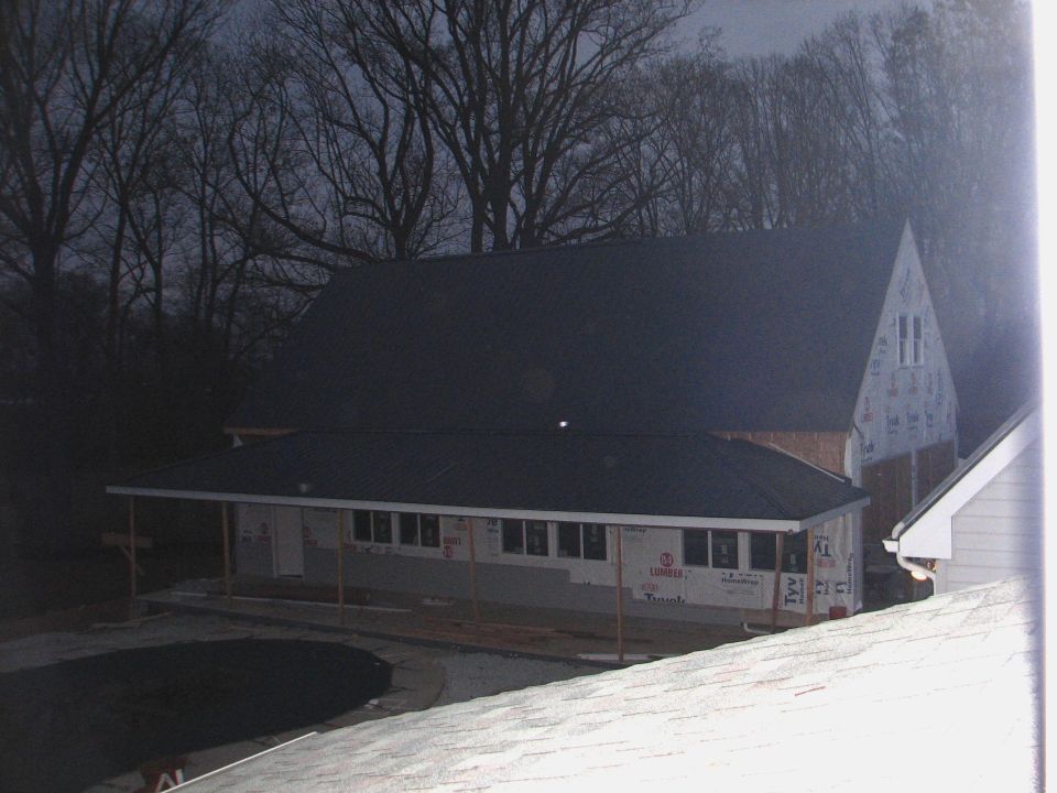 House under construction at dusk wrapped in Tyvek house wrap