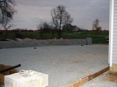 1992 Ford Bronco - A construction scene unfolds with a gravel lot, cinder block wall, and a house visible in the distance.