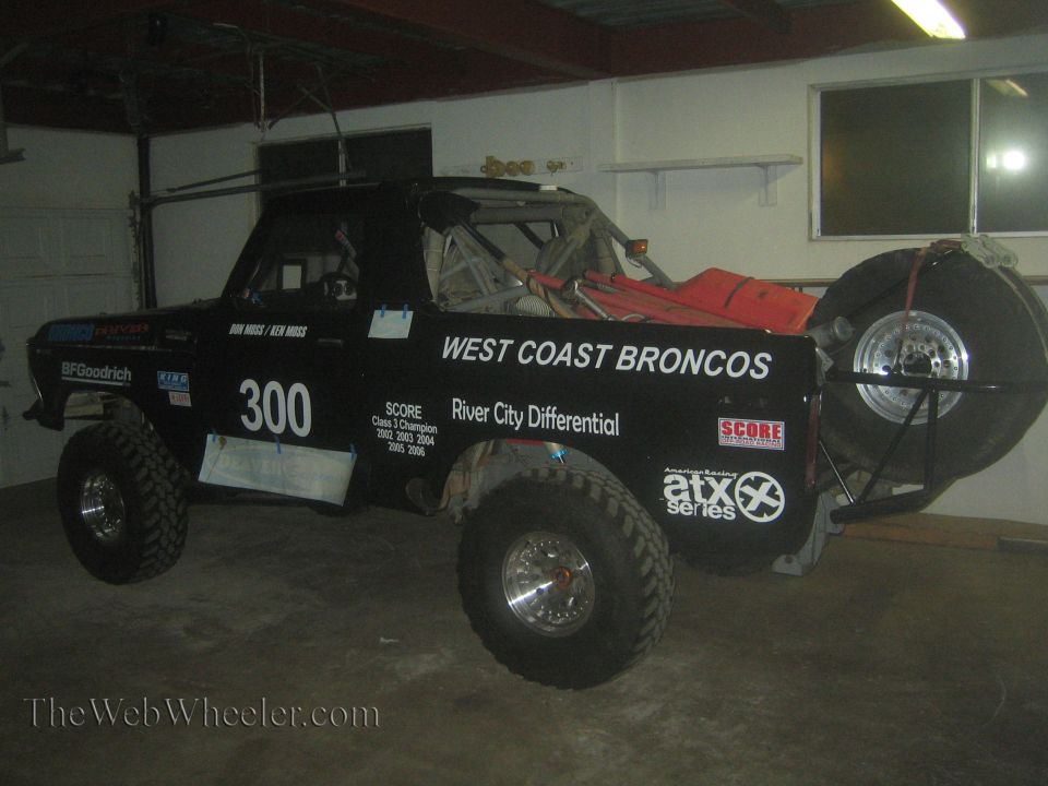 Black West Coast Broncos number 300 off-road race truck in a garage