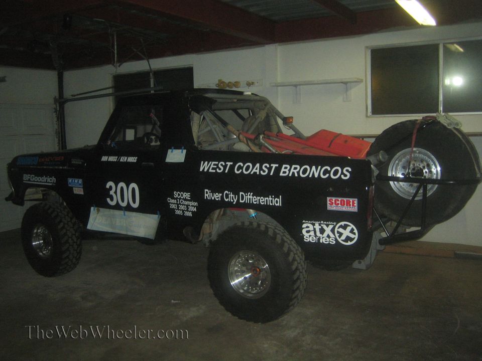 Black West Coast Broncos number 300 race truck parked in a garage