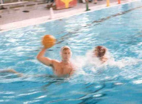 1989 Ford Bronco - Two athletes compete in a water polo match, with one player preparing to throw the ball.