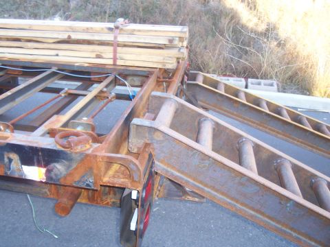 1979 Ford F-350 - ramp hooked on to rear ramp rail of trailer. This rail will allow the ramps to be hooked on to any position on the rear of the trailer. Mak…