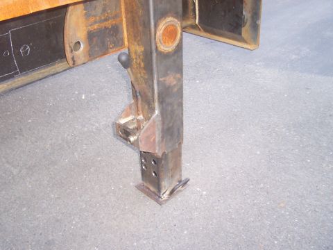 1979 Ford F-350 - rear support jack dropped to ground, and locked in place. There is a locking position every 7/8 of an inch on the "drop leg"