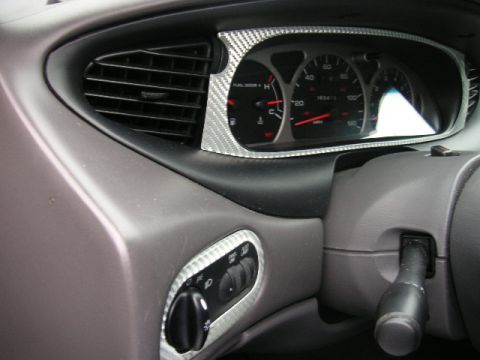 1999 Ford Taurus - The instrument cluster and dashboard details of a 1999 Ford Taurus are visible, including the speedometer and fuel gauge.