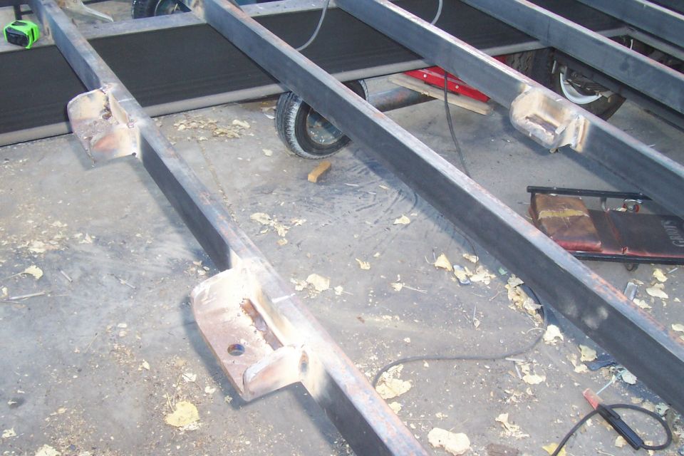 Spare tire cradle made to hang from these three mounts. They are made from 1/2" steel plate, and welded right to the crossmembers