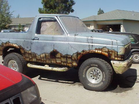 1989 Ford Bronco - This 1989 Ford Bronco features a unique paint job simulating rust and damage.