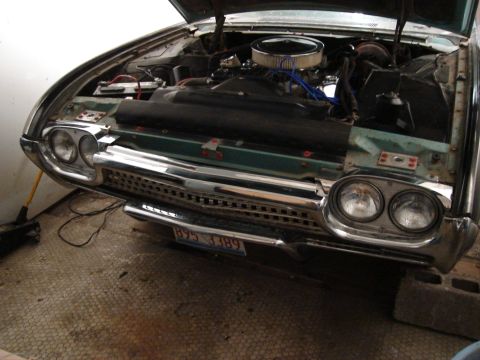 1992 Ford Crown Victoria - Front view of a 1960 Ford Thunderbird with the hood open, revealing the engine and chrome grille.