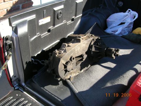 1985 Ford Bronco - A transfer case is shown inside the bed of a pickup truck.