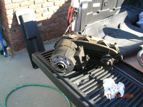 1985 Ford Bronco - Transfer case removed from a vehicle, resting in a truck bed.