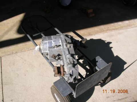 1985 Ford Bronco - A transfer case sits on a dolly, ready for transport or installation.