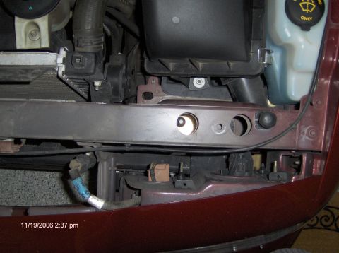 2004 Ford Crown Victoria - Close-up view of engine bay components and a maroon fender, with a timestamp of 11/19/2006.