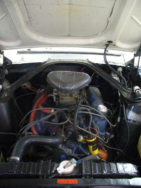 1968 Ford Mustang - Engine bay of a 1968 Ford Mustang, showing the V8 engine and associated components.