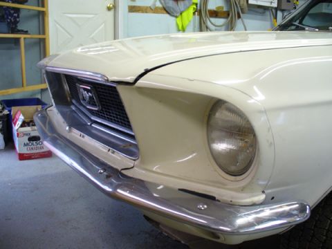 1968 Ford Mustang - The front grille and headlight assembly of a white 1968 Ford Mustang are visible in this close-up shot.