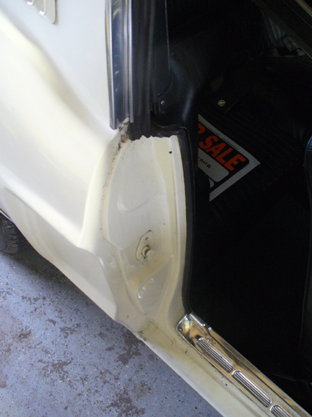 1968 Ford Mustang - A close-up view of the door jamb area of a vehicle, with a 'for sale' sign visible inside.