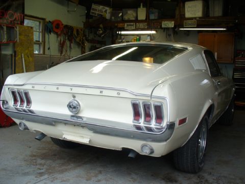 1968 Ford Mustang - Rear view of a white 1968 Ford Mustang fastback parked in a garage.