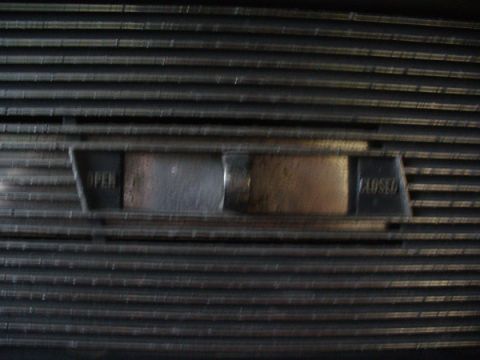 1968 Ford Mustang - Close-up of a vehicle grille showing the 'OPEN' and 'CLOSED' labels for a vent control.