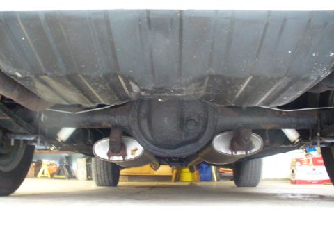 1968 Ford Mustang - Undercarriage view showing the differential and dual exhaust pipes of a vehicle.