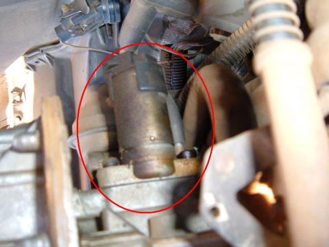 1985 Ford Bronco II - Close-up view of a starter motor, a crucial component for igniting a vehicle's engine.
