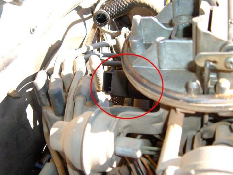 1985 Ford Bronco II - Electrical connector on a carburetor, part of the engine's fuel delivery system.
