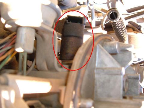 1985 Ford Bronco II - This image shows a close-up view of a vehicle's engine compartment, focusing on a specific part with wiring.