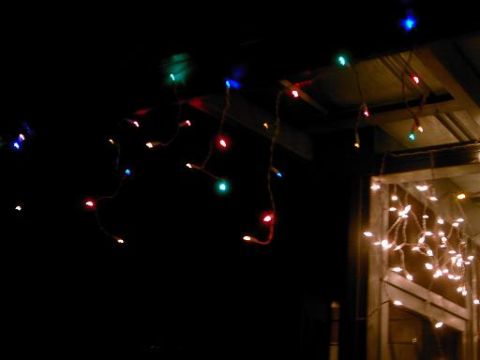 1986 Ford Bronco - Holiday lights illuminate a dark outdoor scene.
