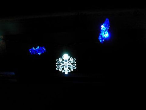 1986 Ford Bronco - Decorative Christmas lights, including a snowflake and blue icicle shapes, are illuminated in the dark.