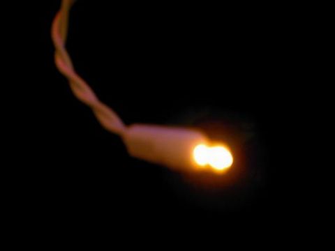 1986 Ford Bronco - A single illuminated Christmas light glows warmly against a dark background.