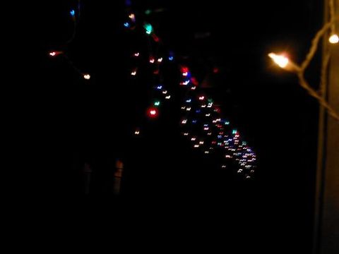1986 Ford Bronco - Colorful Christmas lights are strung up against a dark background.