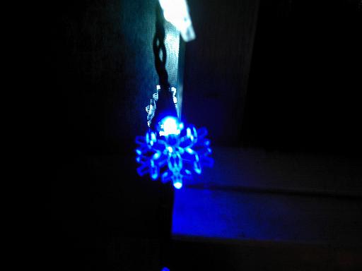 Close-up of blue Christmas lights against a dark background