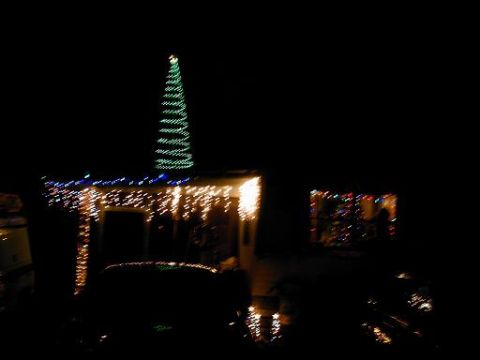 1986 Ford Bronco - House decorated with Christmas lights, a tree shape made of lights on the roof.
