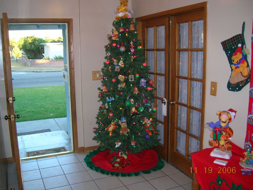 Christmas tree with ornaments and a Winnie the Pooh stocking hanging on the wall, with a date stamp of 11.19.2006