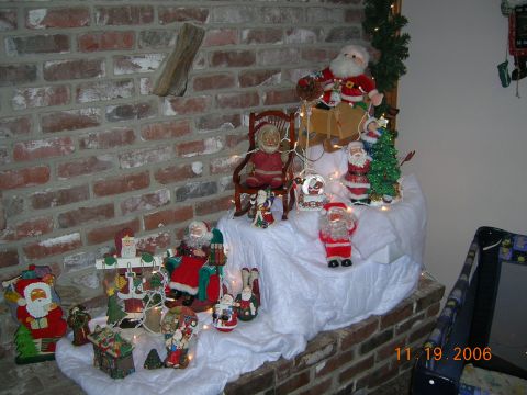 1985 Ford Bronco - A festive display of Santa figures and a Christmas tree adorns a brick hearth, dated November 19, 2006.