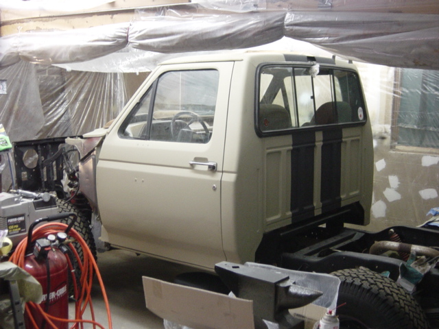 Side view of a 1991 Ford Bronco cab, beige with black stripes