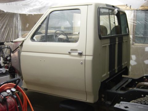 1991 Ford Bronco - Side view of a 1991 Ford Bronco cab and bed section in a workshop.