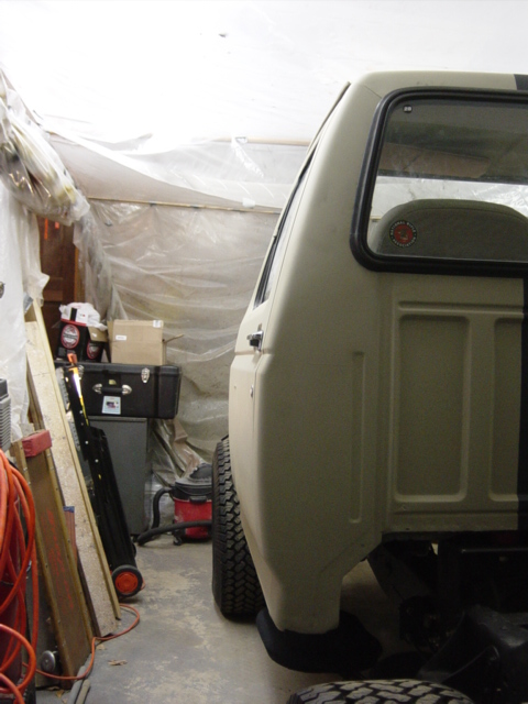 1991 Ford Bronco - The rear section of a Ford Bronco is visible in a cluttered garage setting.